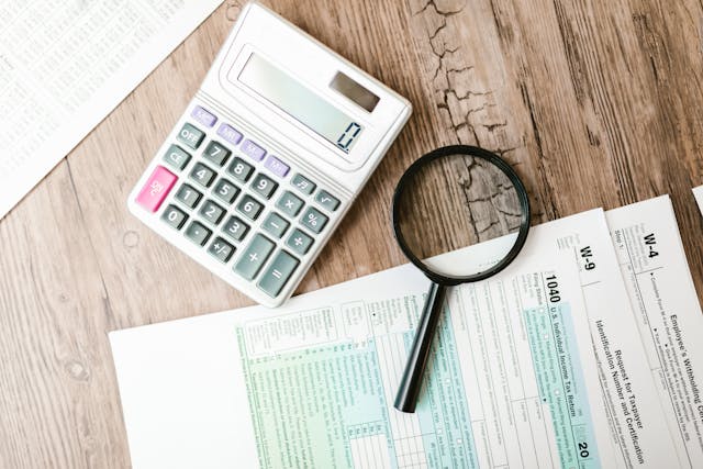 a%20calculator%20and%20magnifying%20glass%20on%20a%20tax%20form